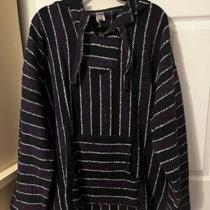 Men’s 2x hooded poncho. Long sleeve black and purple stripes.